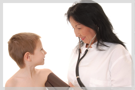 doctor checking a kid's blood pressure